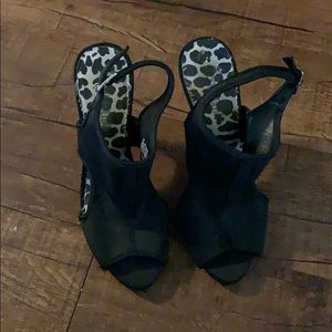 Five in black stretchy heels. Peep toe.